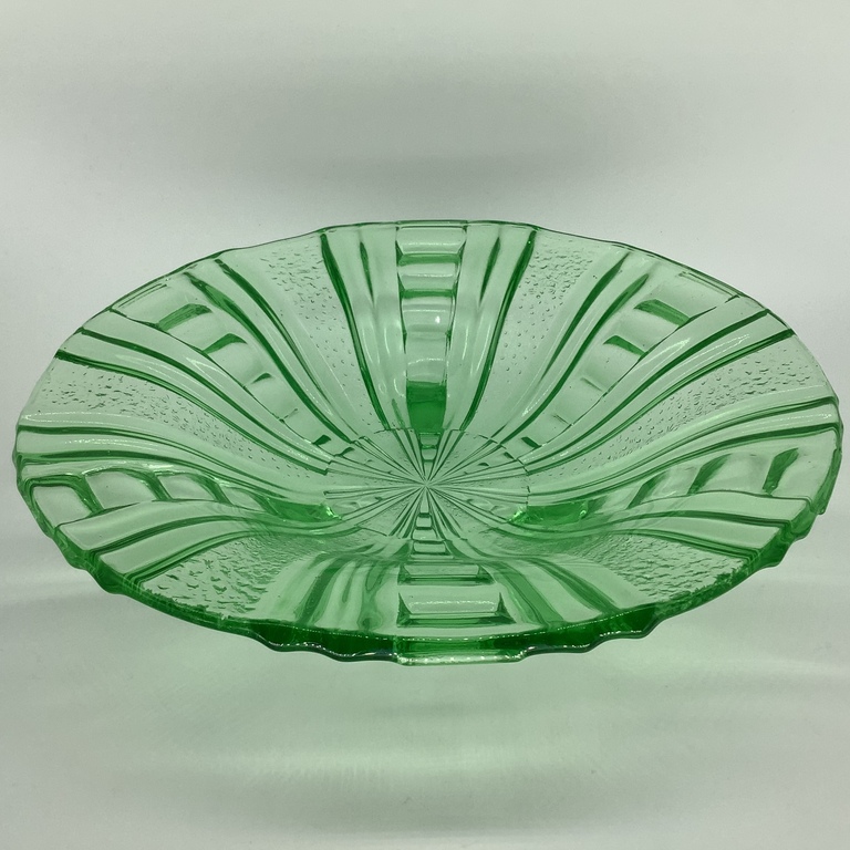 A large bowl of fruit. Green glass. Photography in ultraviolet light.