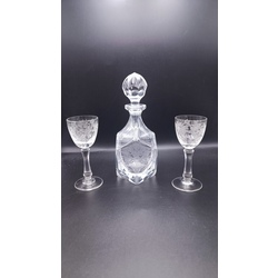 A very elegant small decanter with two glasses