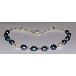 Necklace with dark freshwater pearls, crystals and zirconia elements.