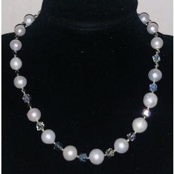 Necklace with white Edison freshwater pearls, Austrian crystals and a magnetic clasp with cubic zirconias.