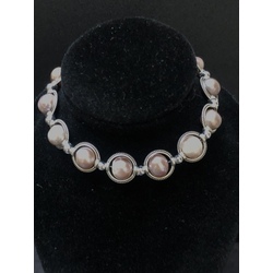 Bracelet with lavender colored beads, zirconia clasp and other metal elements.