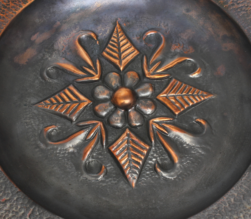 Metal plate with folk motif
