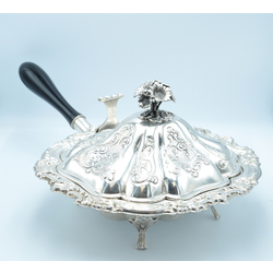 Silver hot dish with wooden handle