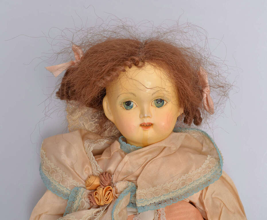 Antique biscuit doll in a pink dress