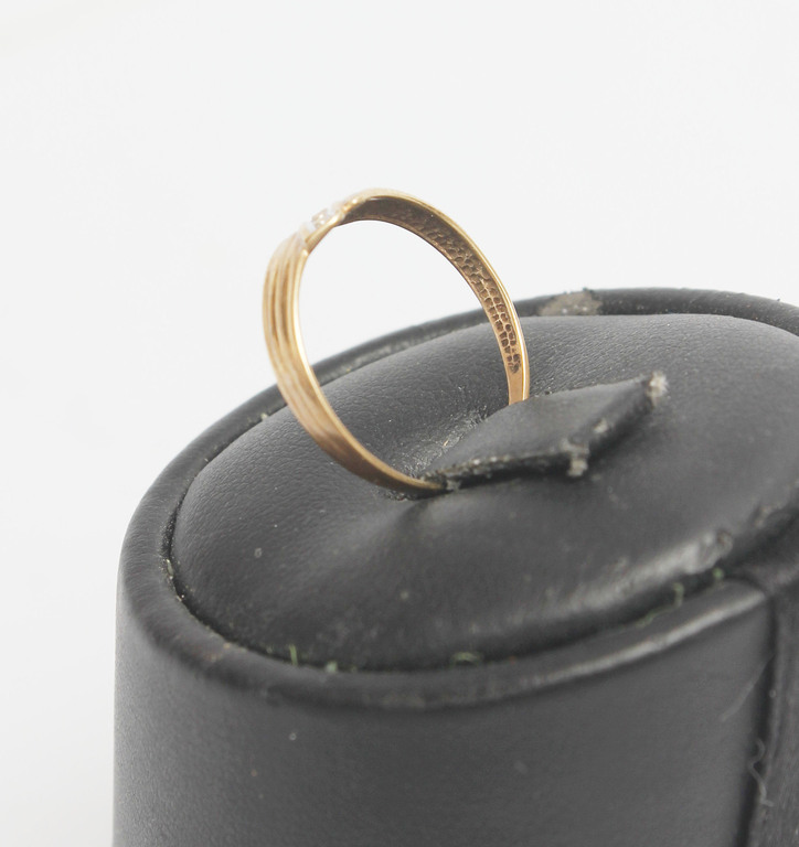 Gold ring with a small diamond