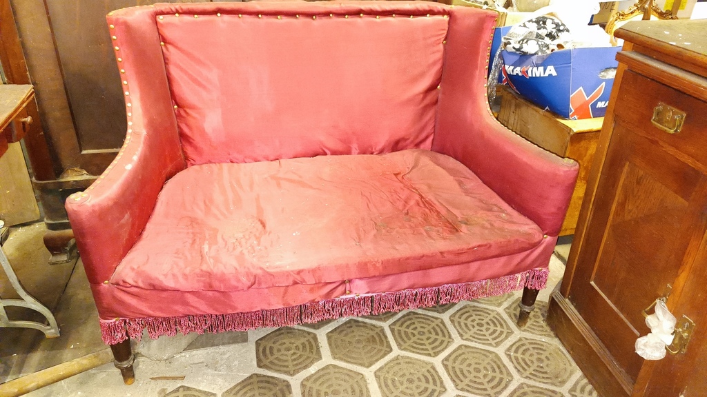 Sofa upholstered with red fabric