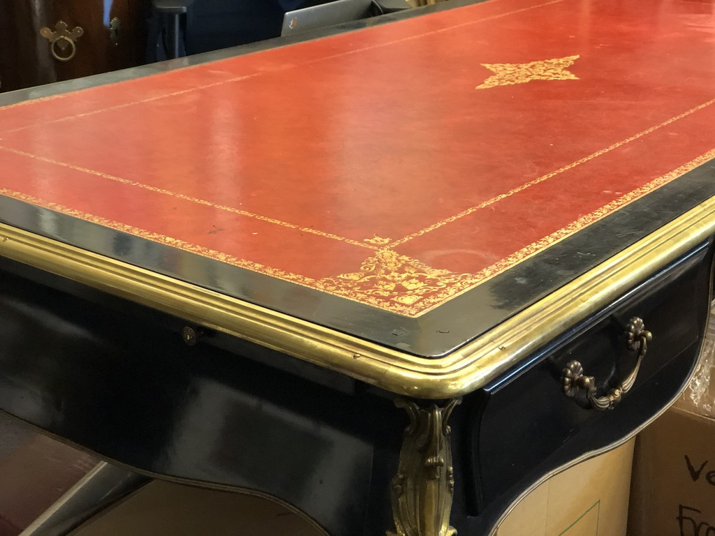 Ebony table with leather surface and gilded bronze finishing details