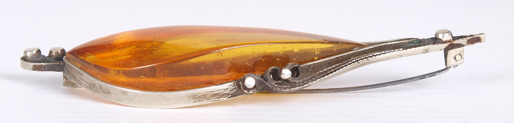 Amber brooch in metal