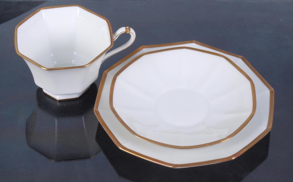 Porcelain cup with two saucers