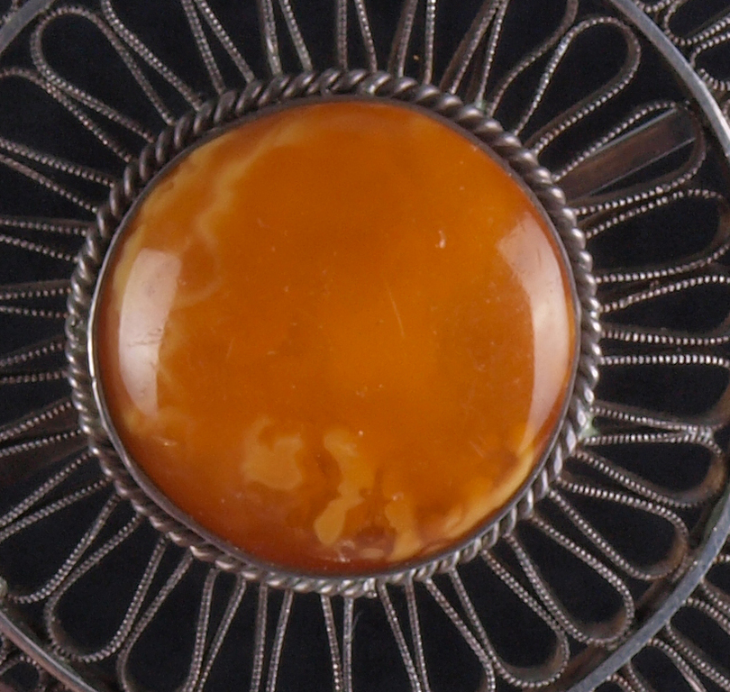 Silver brooch with amber